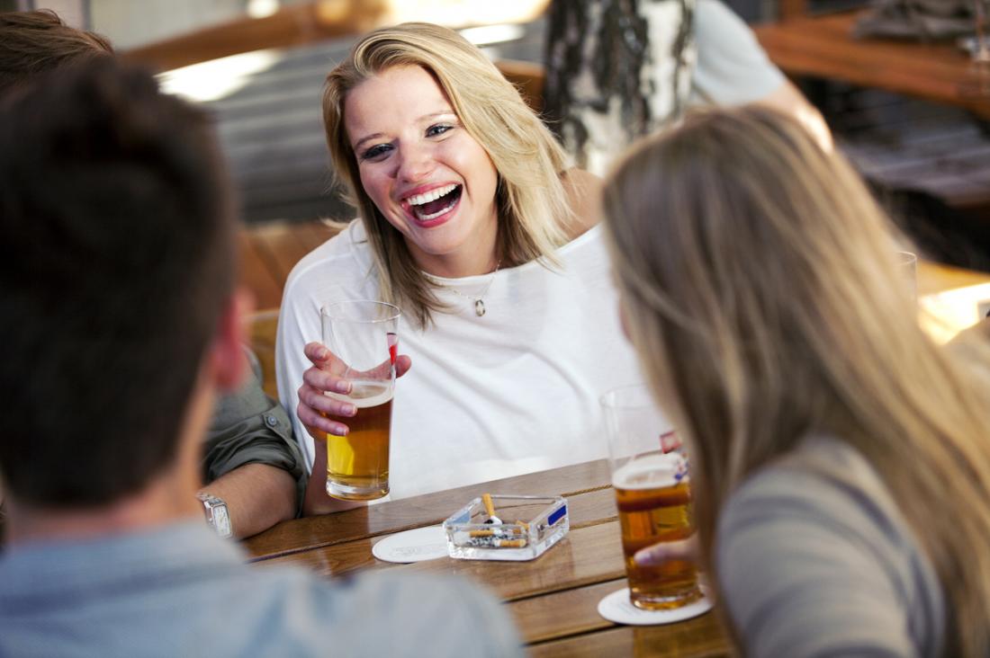 woman drinking and smoking with friends