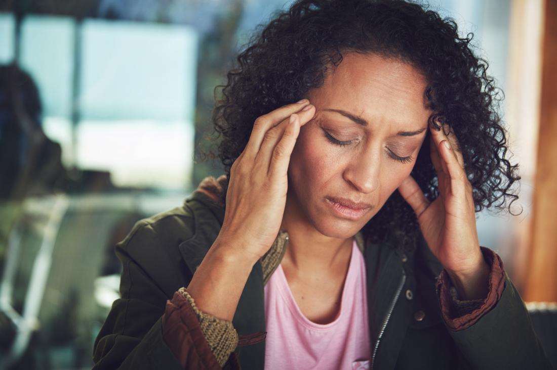 Woman with migraine headache.