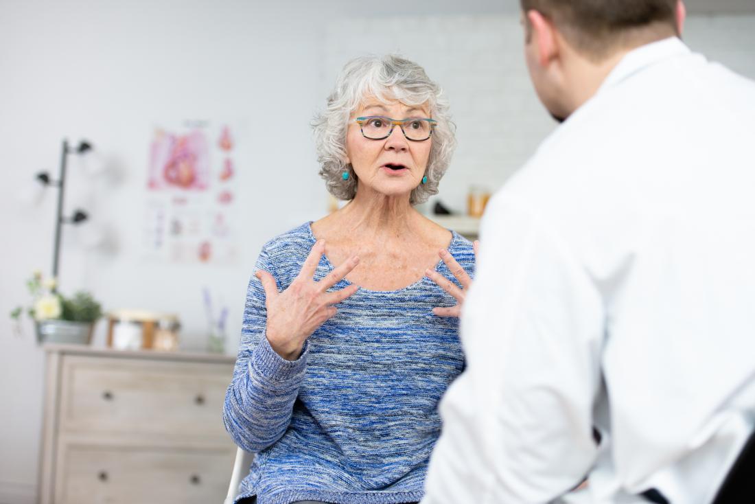 a woman explains her symtoms to a doctor