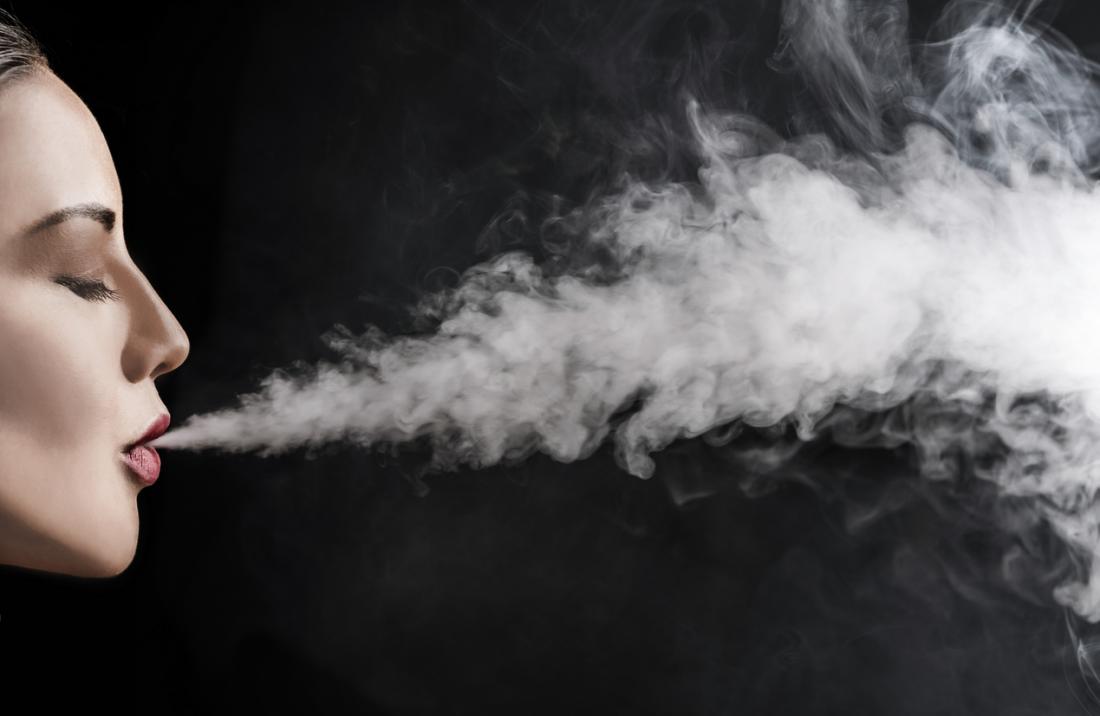 woman exhaling smoke