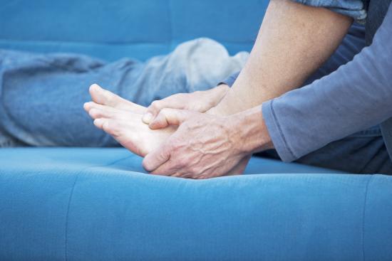 A man holding the ball of his foot.