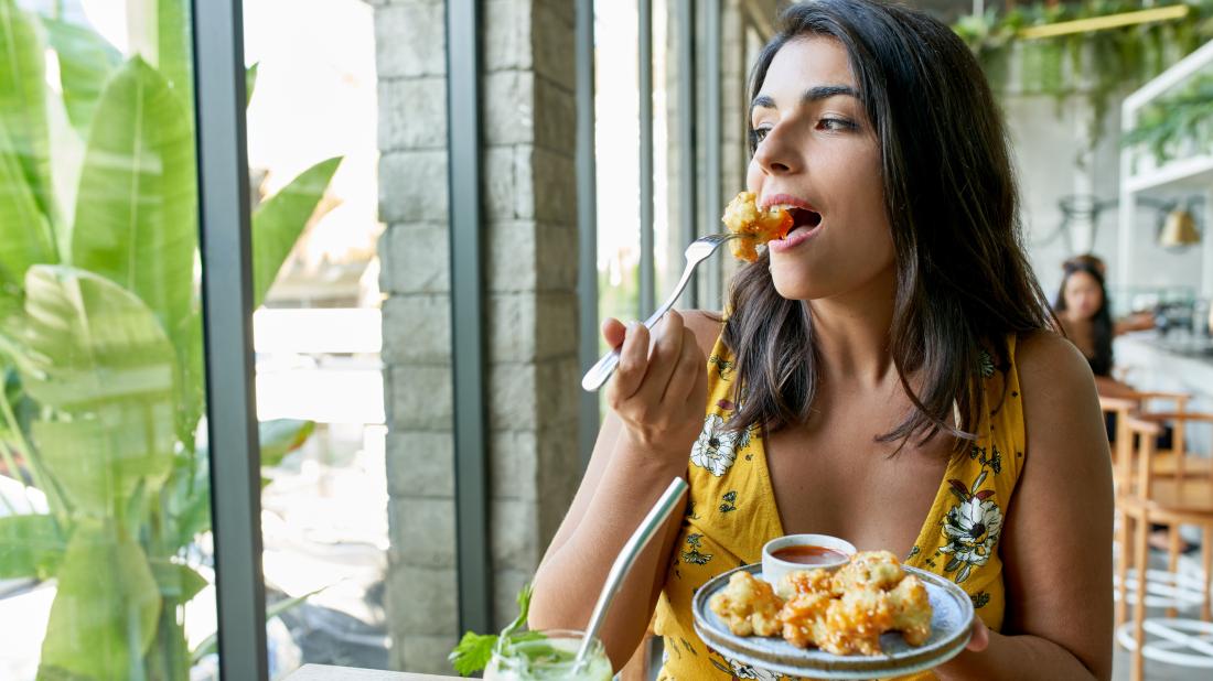 a woman eating a keto meal to help her achieve ketosis
