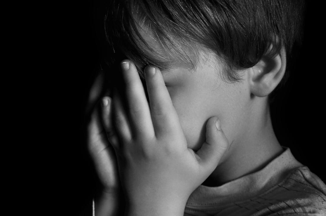 Sad child in the shadows