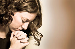 Lonely girl clasping hands together