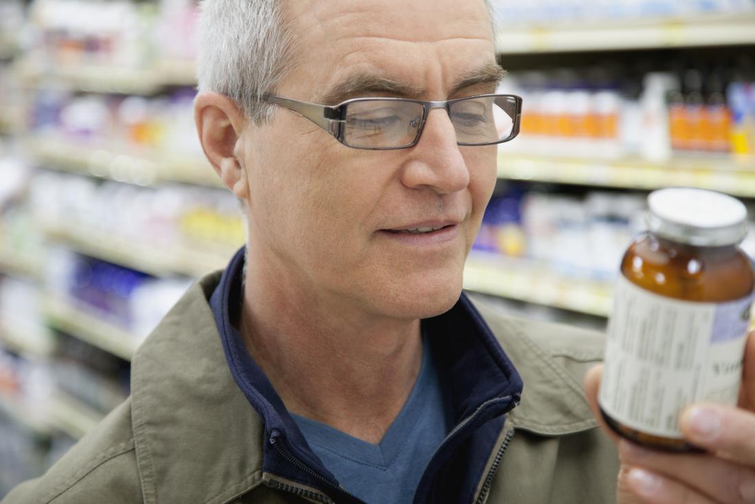man checking supplements label