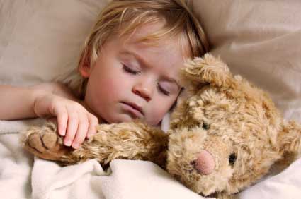 Child sleeping with teddy bear
