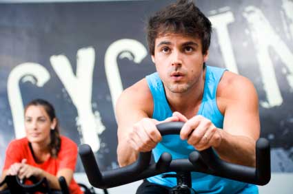 Man and woman on exercise bike