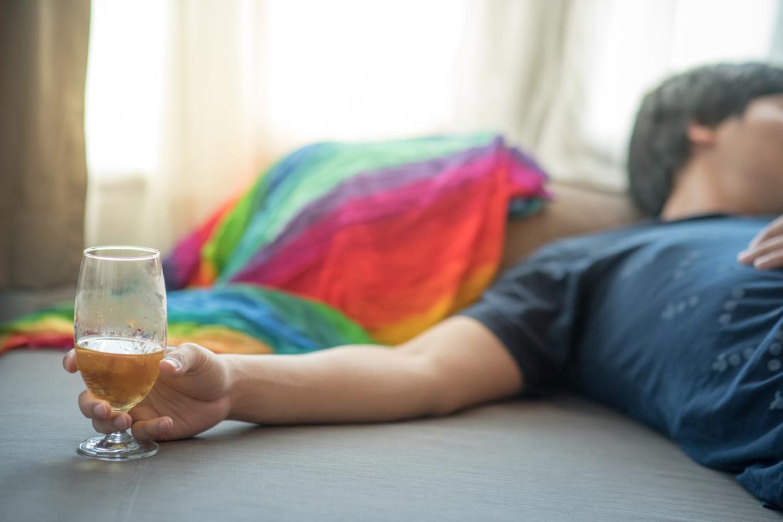 Man drinking in bed