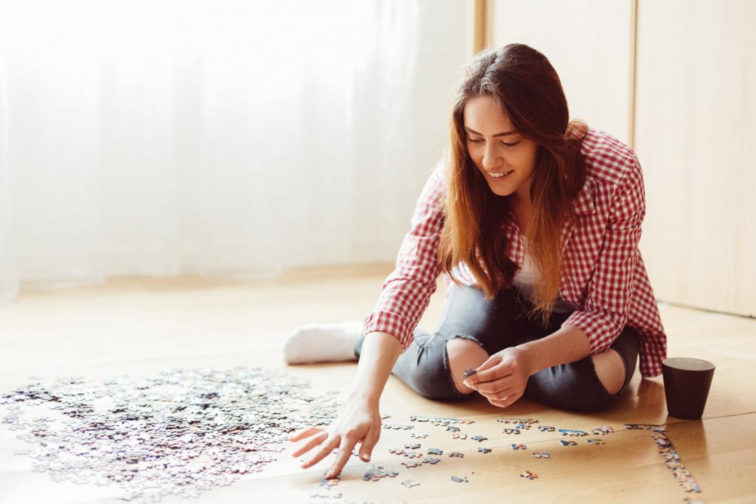 Woman completing jigsaw