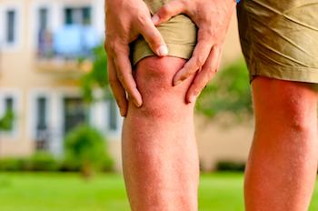 Man holding his knee