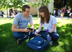 a couple sitting outside texting