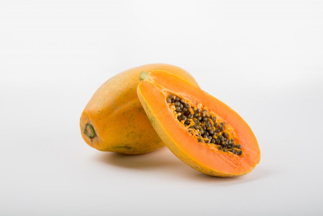 Papaya fruit cut in half with seeds showing.