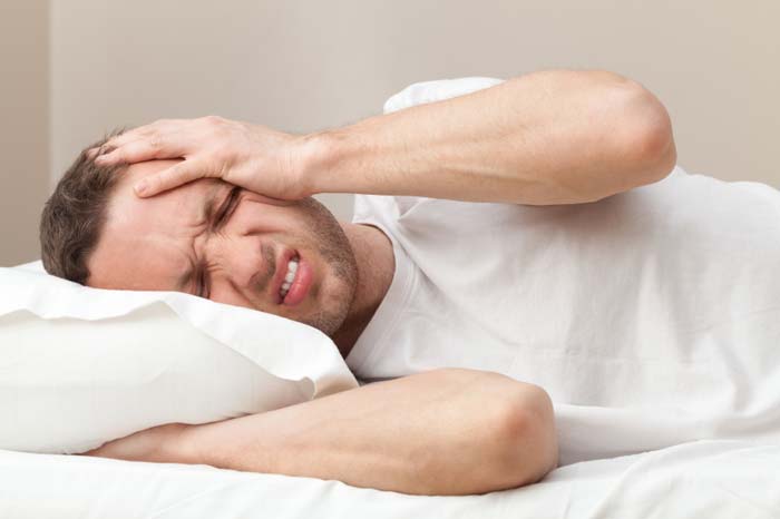 Man suffering with a migraine
