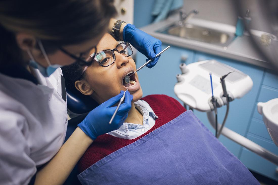 Woman in dentists office having check up of teeth