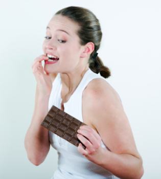 Lady looking at an unwrapped bar of chocolate
