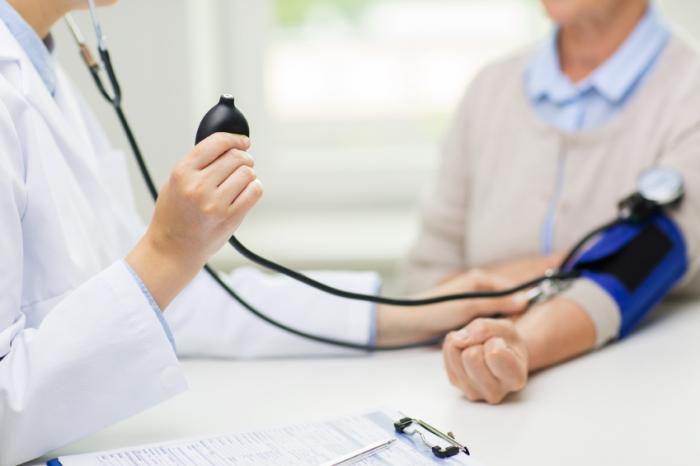 a doctor measuring blood pressure of older adults