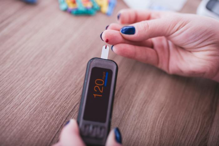 woman takes blood sugar test