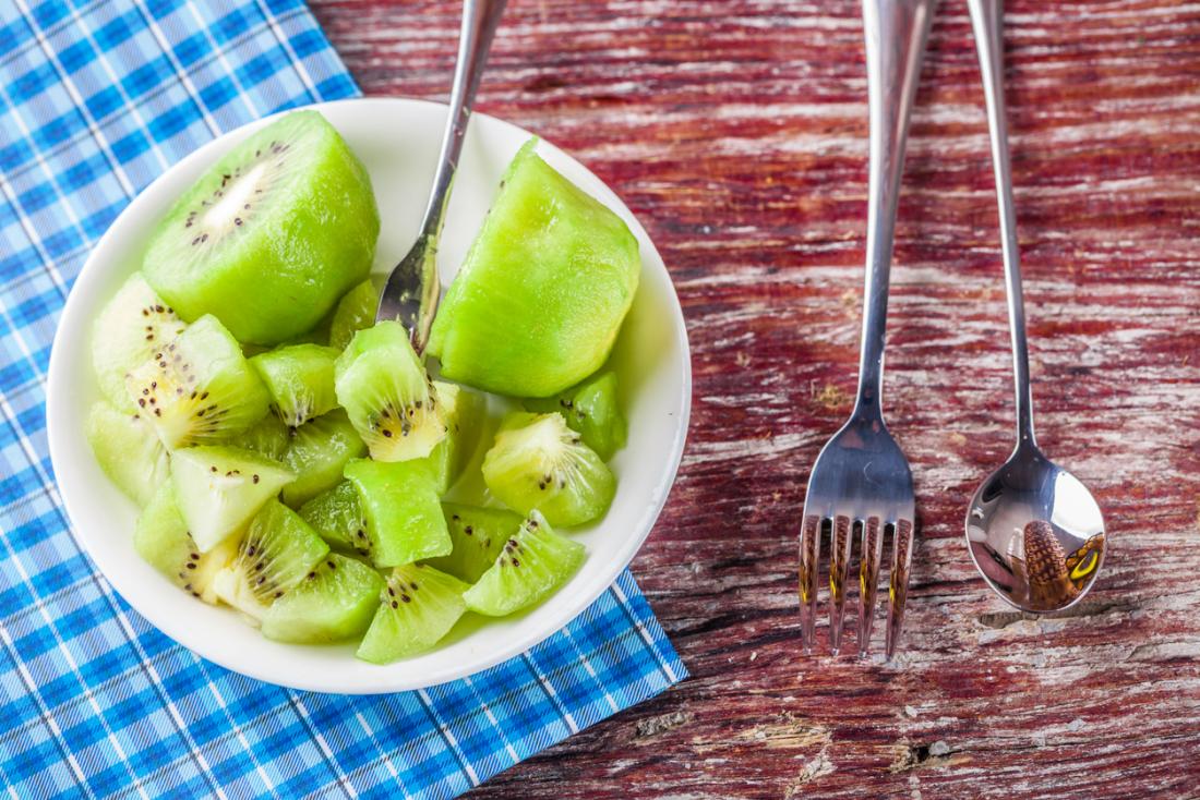 cut up kiwi in a white bowl