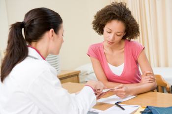 Health care professional talking to a female patient