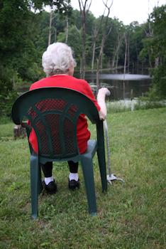 Older lady sitting by a lake