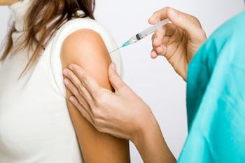 teenage girl being vaccinated