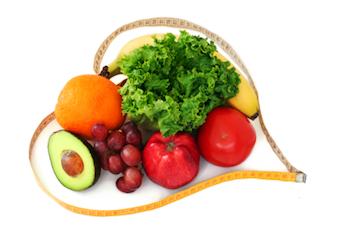Fruit and veg surrounded by a tape measure in the shape of a heart.