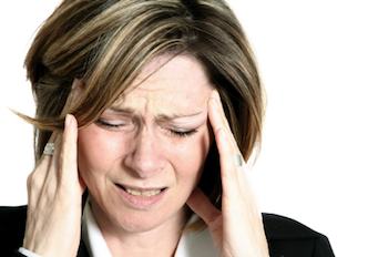 Lady with a headache holding her head