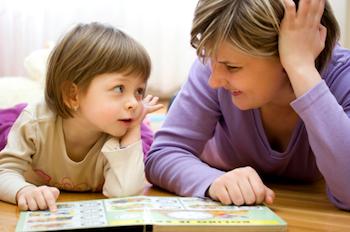Preschooler reading with her mother