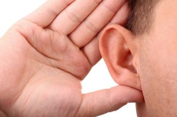 a person cupping their hand to their ear