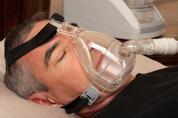 Man sleeping wearing CPAP mask