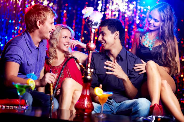 Young people enjoying hookah pipe smoking