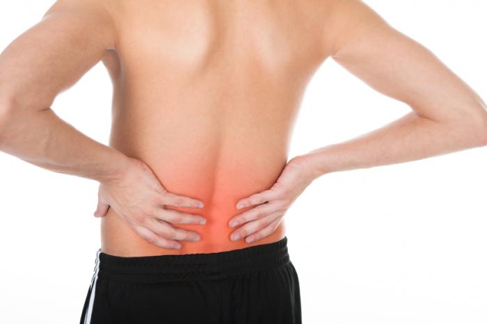 man clutching his lower back