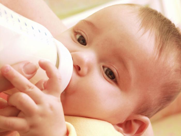 Baby being bottle fed