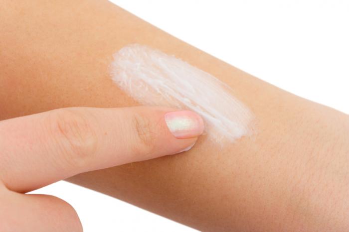 Woman using moisturizer