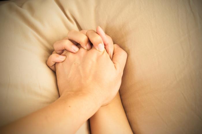 Holding hands on a pillow