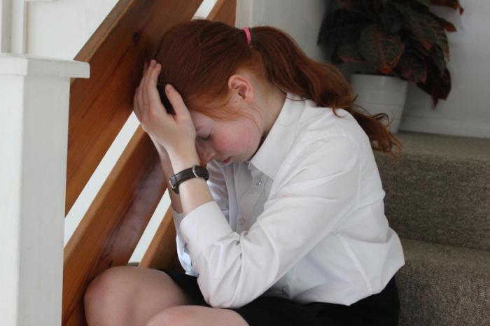 Stressed girl sitting on the stairs