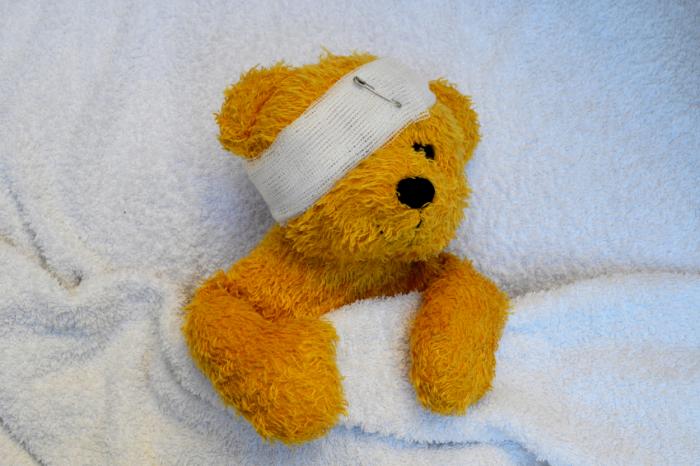 Teddy bear with bandaged head.