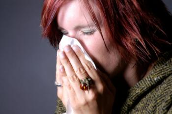 woman blowing nose into tissue