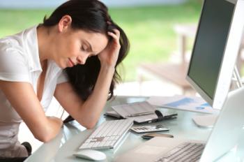 A tired woman at a computer