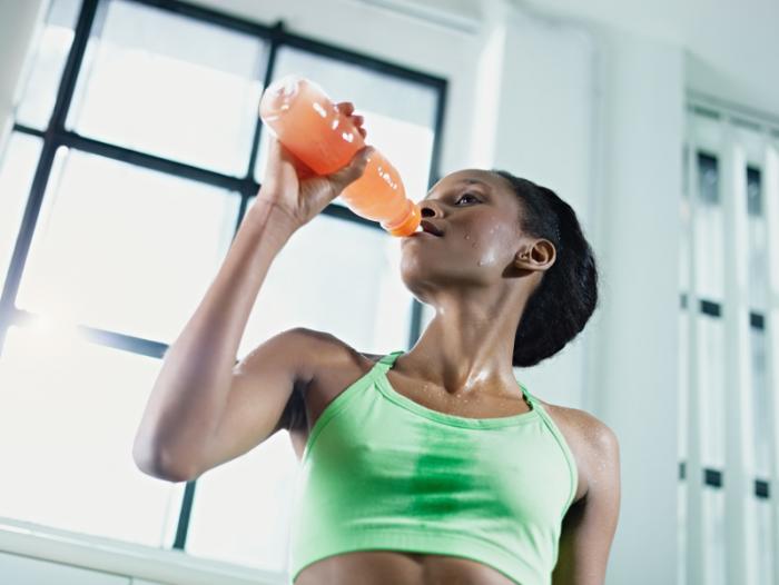 woman at gym drinking juice