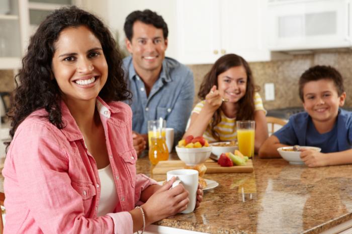Family sitting down for healthy breakfast.