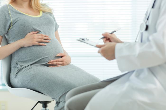 Pregnant woman having a check up with a clinician.