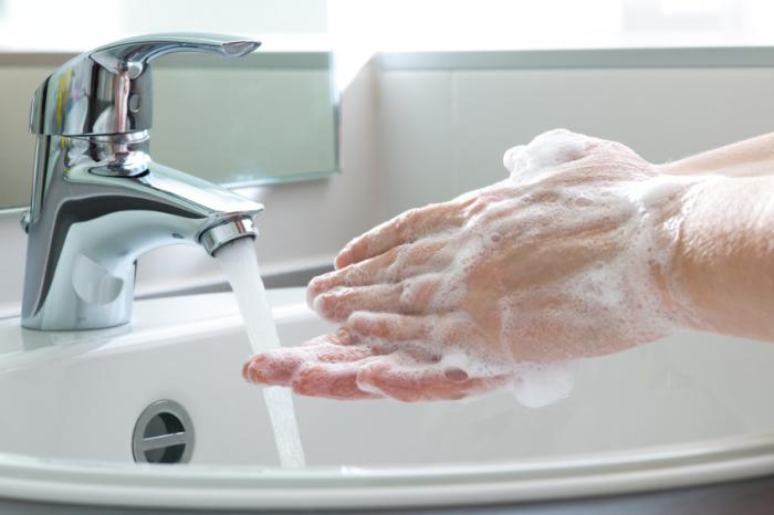 Washing hands with soap.