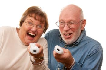Two older adults holding Wii controllers.