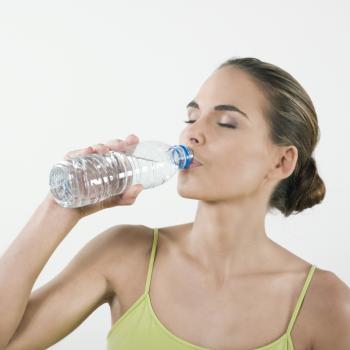 A woman drinking a bottle of water