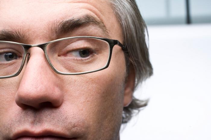 A cynical man wearing glasses.
