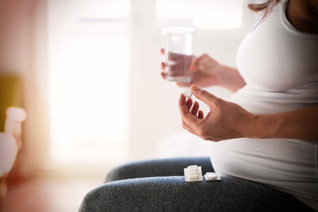 Pregnant woman taking multi-vitamins