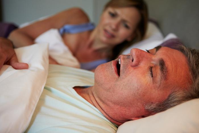 man asleep in bed with mouth open
