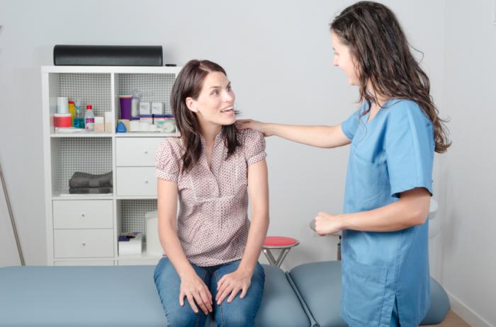 A woman having an appointment with a physiotherapist.