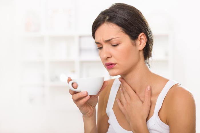 an ill woman drinking some tea